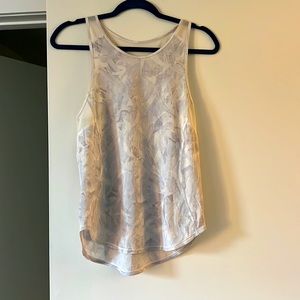 Lululemon white tank top with gray prints and mesh panels under the arms. Size 4